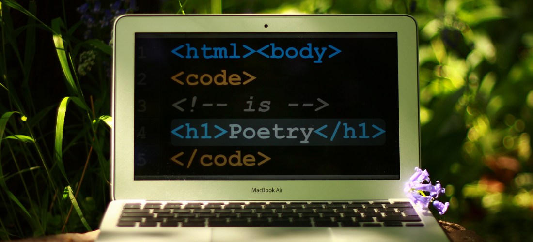 A laptop with html code and the word Poetry on the screen.