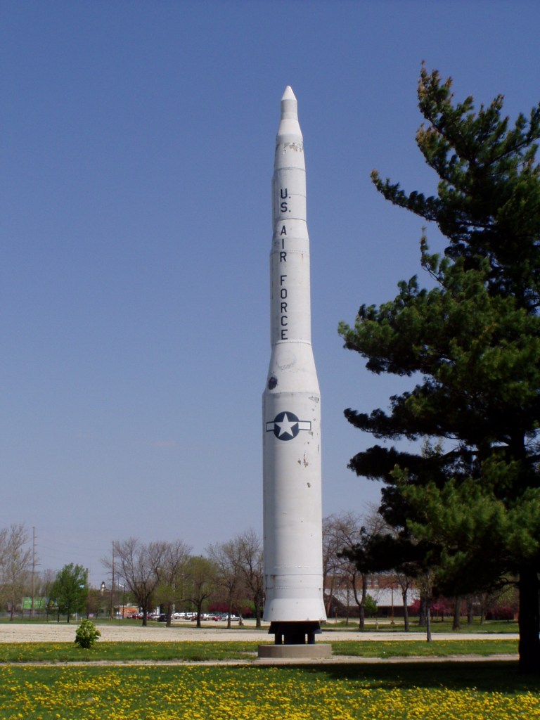 White missile standing in a field. 