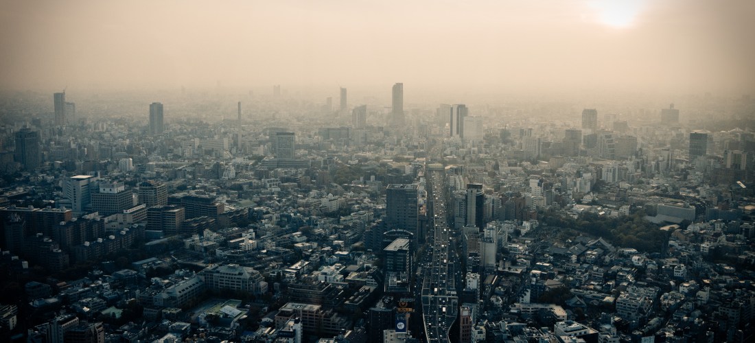 An aerial view of a city showing a smoggy sky above the buildings.