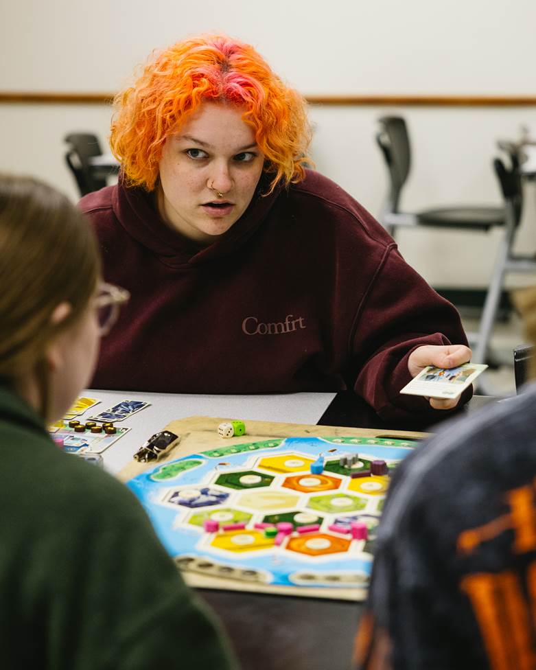 Two students talk to each other as part of the game.