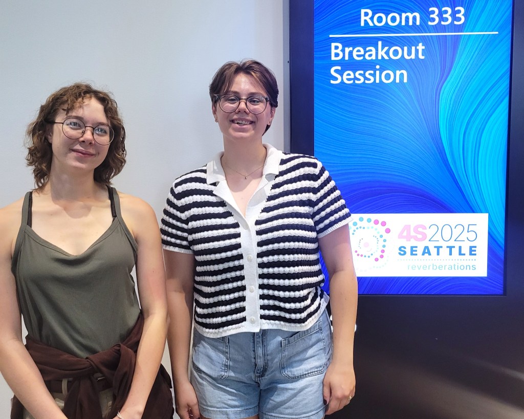 STS students Claire Linn and Parker Smith next to one of the 4S 2025 breakout session signs. 